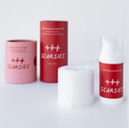 Scar treatment products including a pink roll-on, red container, and white gel tube on a light gray background.