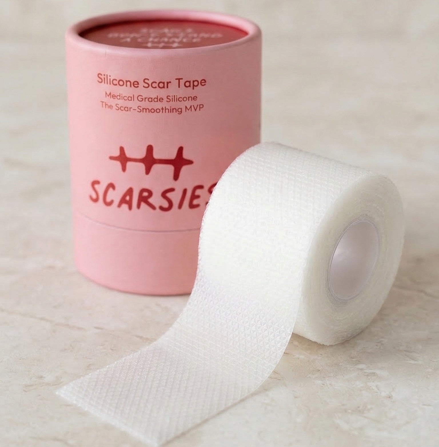 Roll of silicone scar tape with pink container labeled 'SCARSiE' on a light background